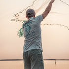 fisherman throwing a cast net