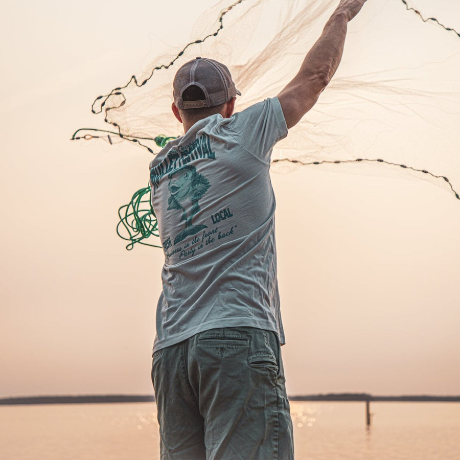 fisherman throwing a cast net